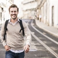 portrait-of-smiling-young-man-with-backpack-in-the-2022-12-16-22-25-17-utc.jpg