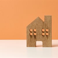 brown-wooden-house-on-a-orange-background-real-es-2022-06-15-20-45-05-utc.jpg